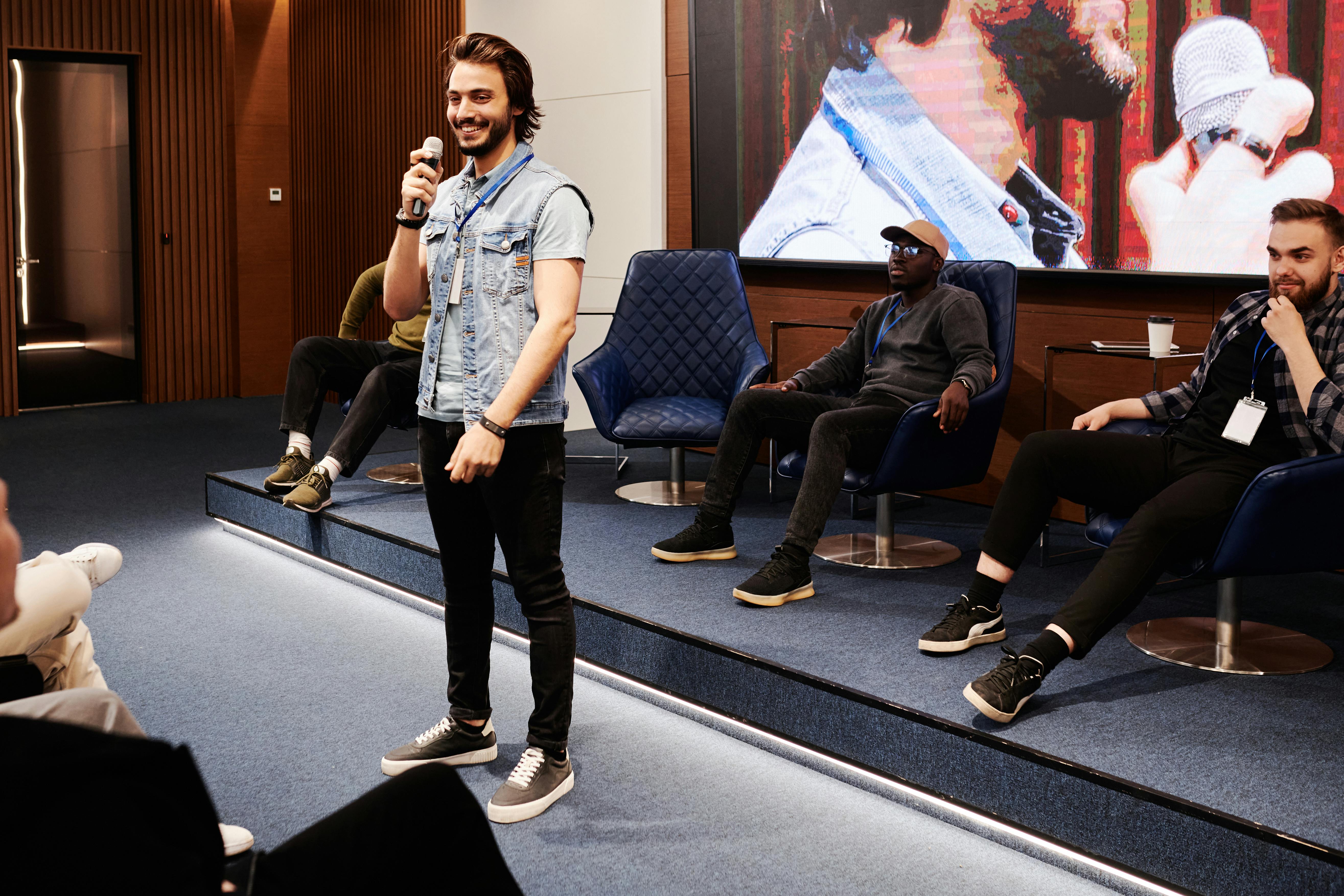 A speaker engages the audience with public speaking in a modern conference setting.